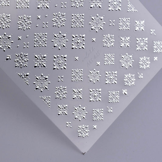 Detail view of nail decal sheet on light background.