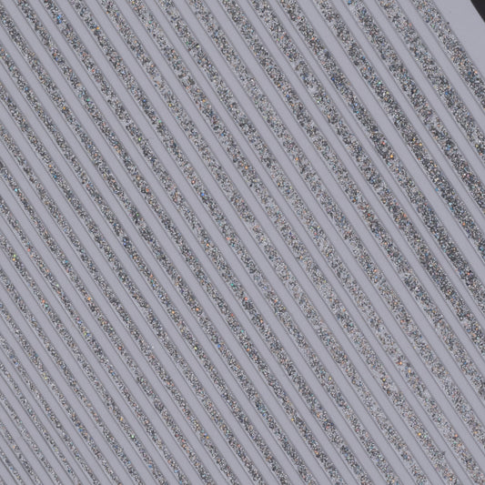 Close up view of silver glitter line nail stickers on white background.