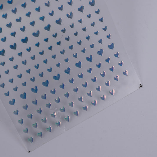 Detail view of nail decal sheet on light background.