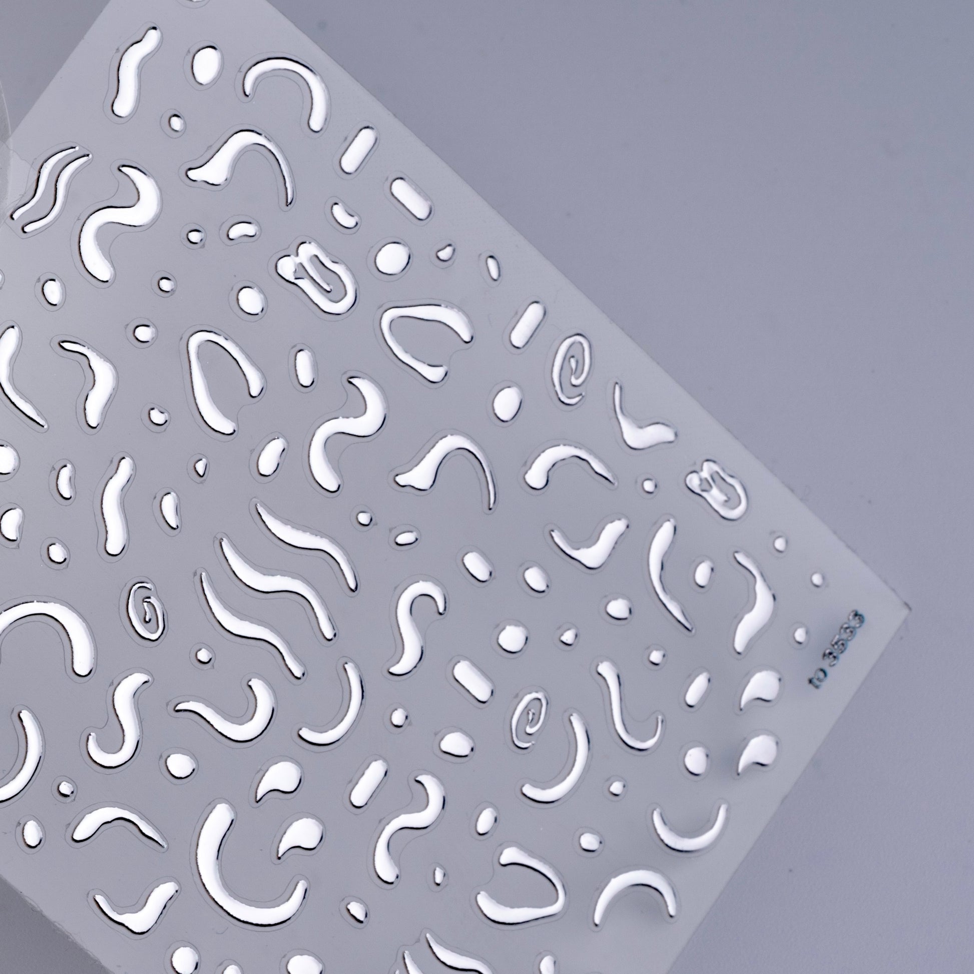 Detail view of nail decal sheet on light background.