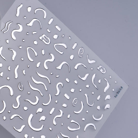 Detail view of nail decal sheet on light background.