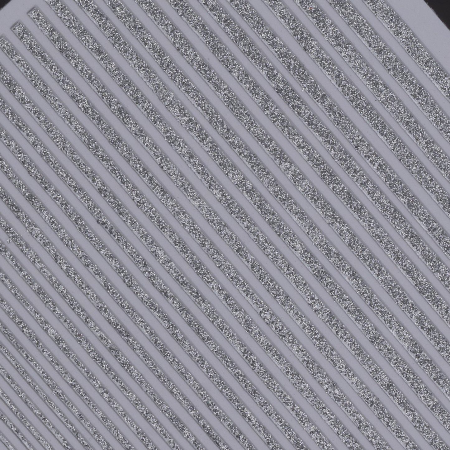 Close-up view of glitter line nail stickers on white background.