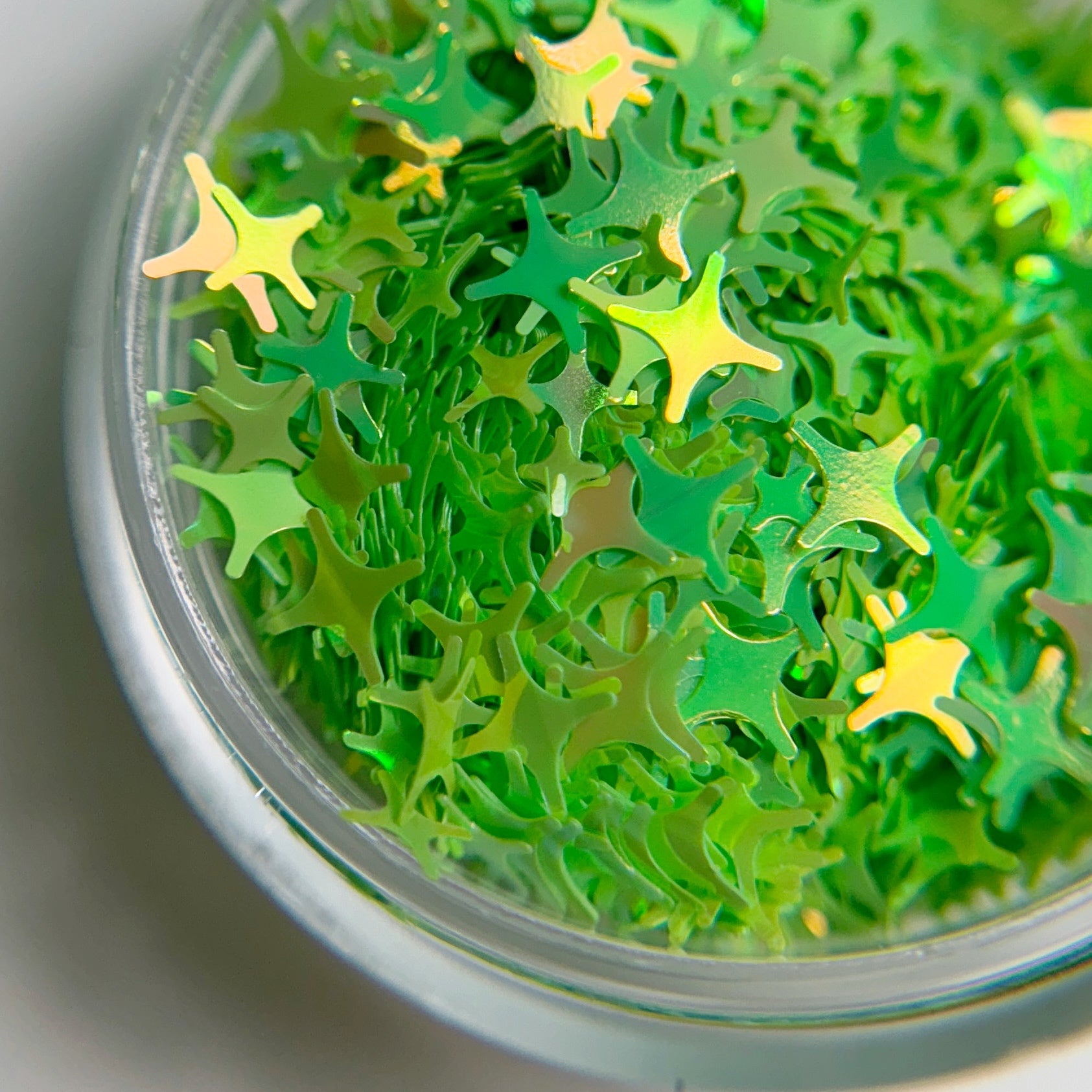 Close-up view of star shaped glitter on blurred background.