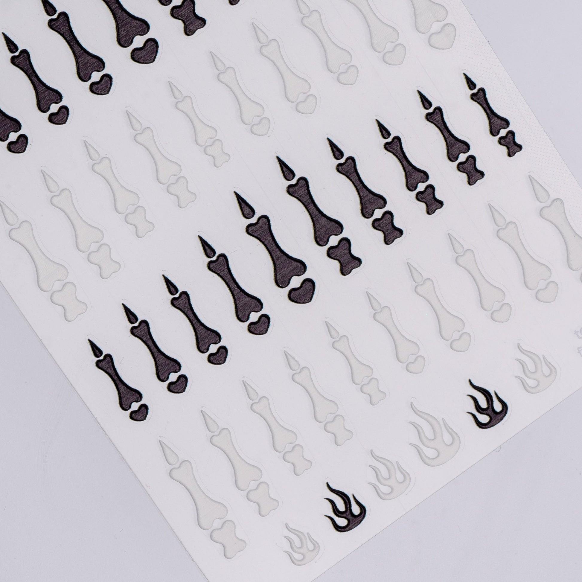 Sheet of black and white nail art stickers on a white background