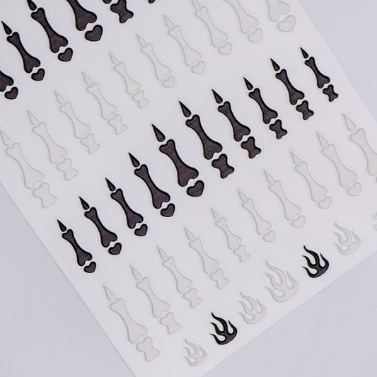 Sheet of black and white nail art stickers on a white background