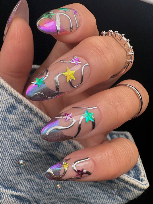 Nail art with stars and metallic designs on a dark background