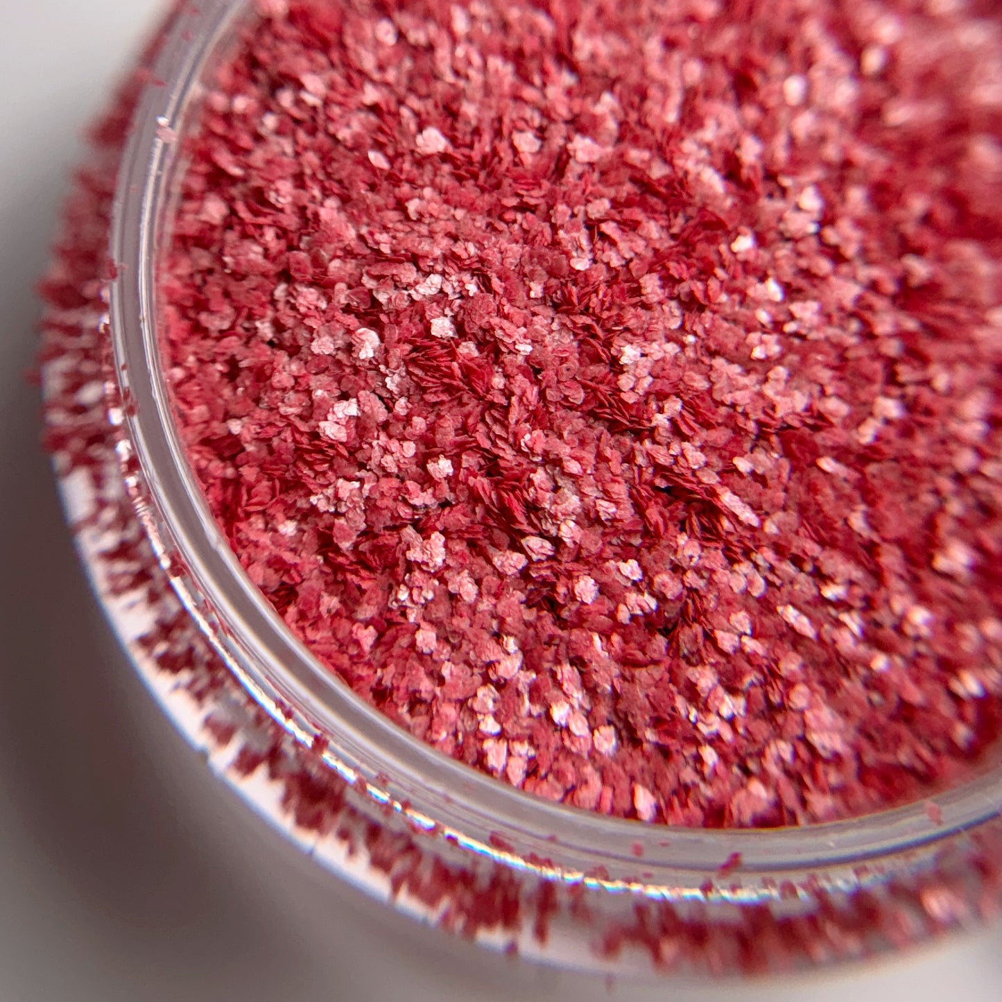 Close-up of a container filled with red glitter.