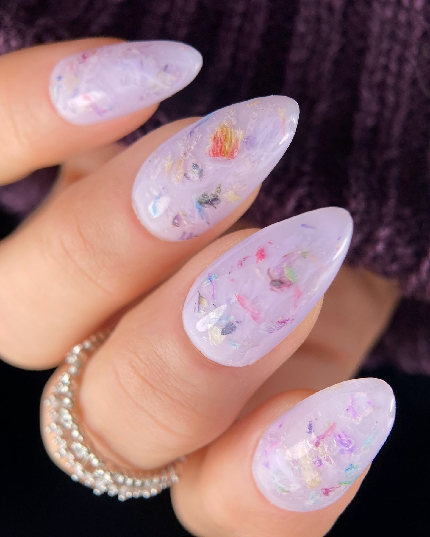 Nails with colorful floral design on a blurred background