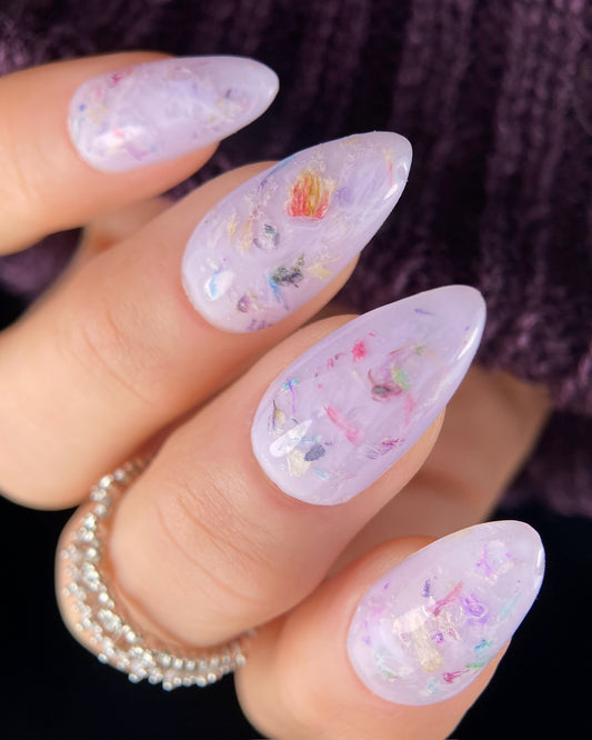 Nails with colorful floral design on a blurred background