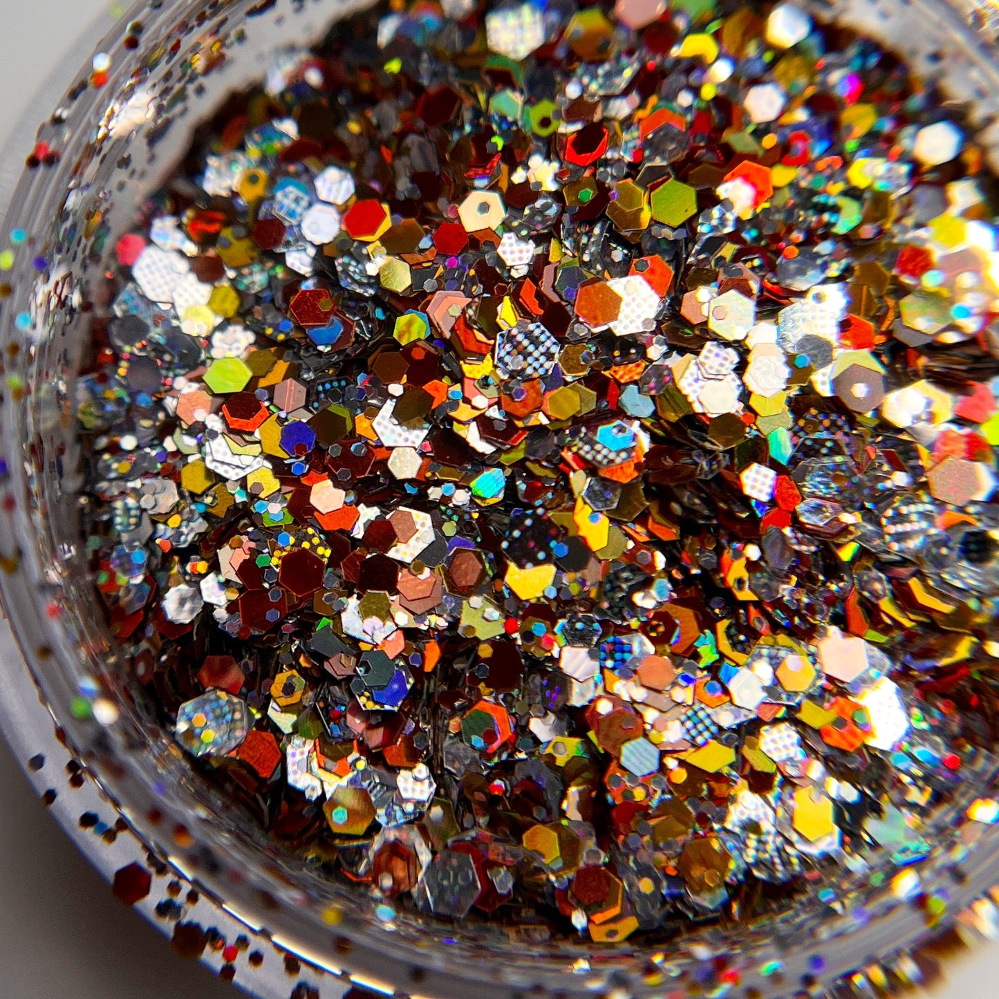 Close up image of multicolor glitter in transparent jar