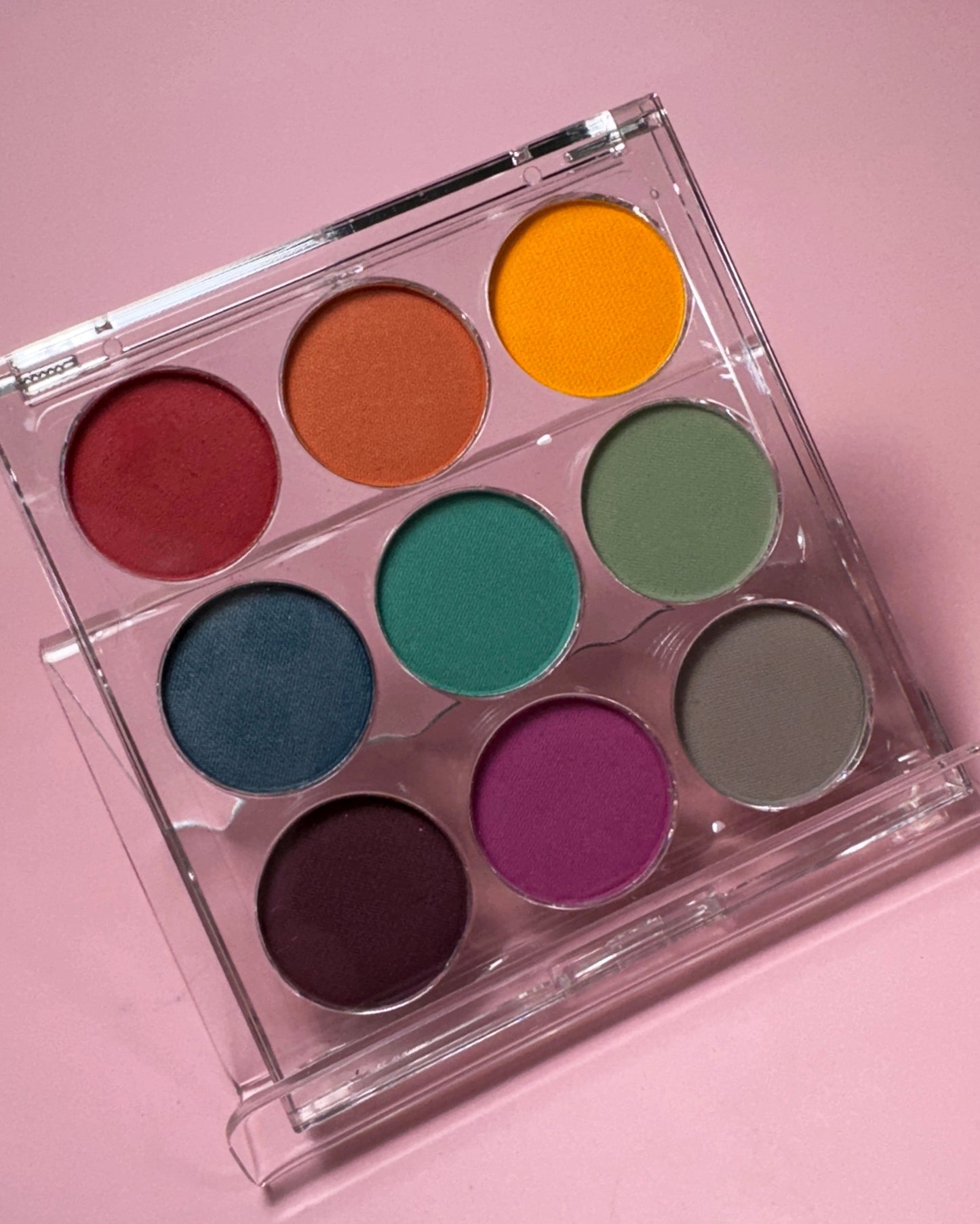 Close up of gradient palette on pink background