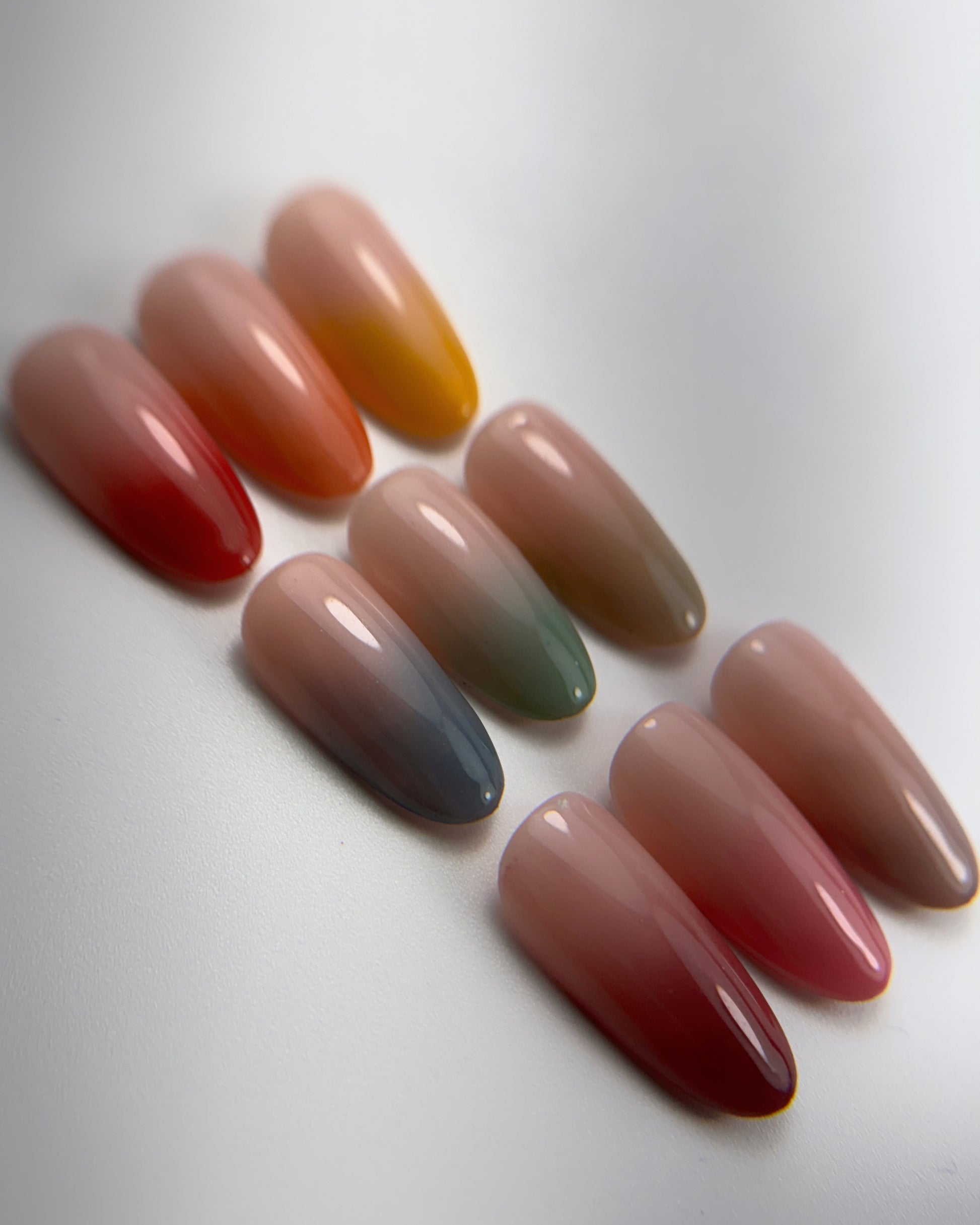 Decorated nail tips on white surface 