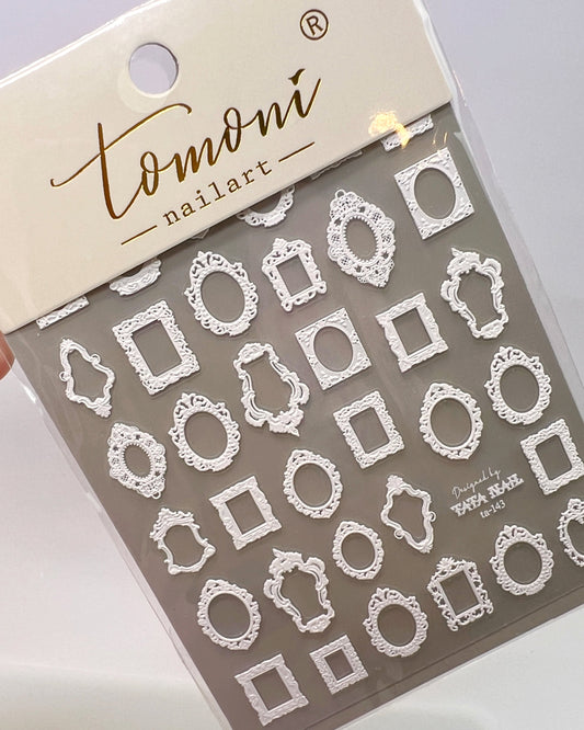 Packaged nail art stickers with lace frame designs  on a neutral background