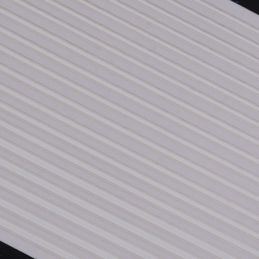 Close-up view of white line nail stickers on white background.