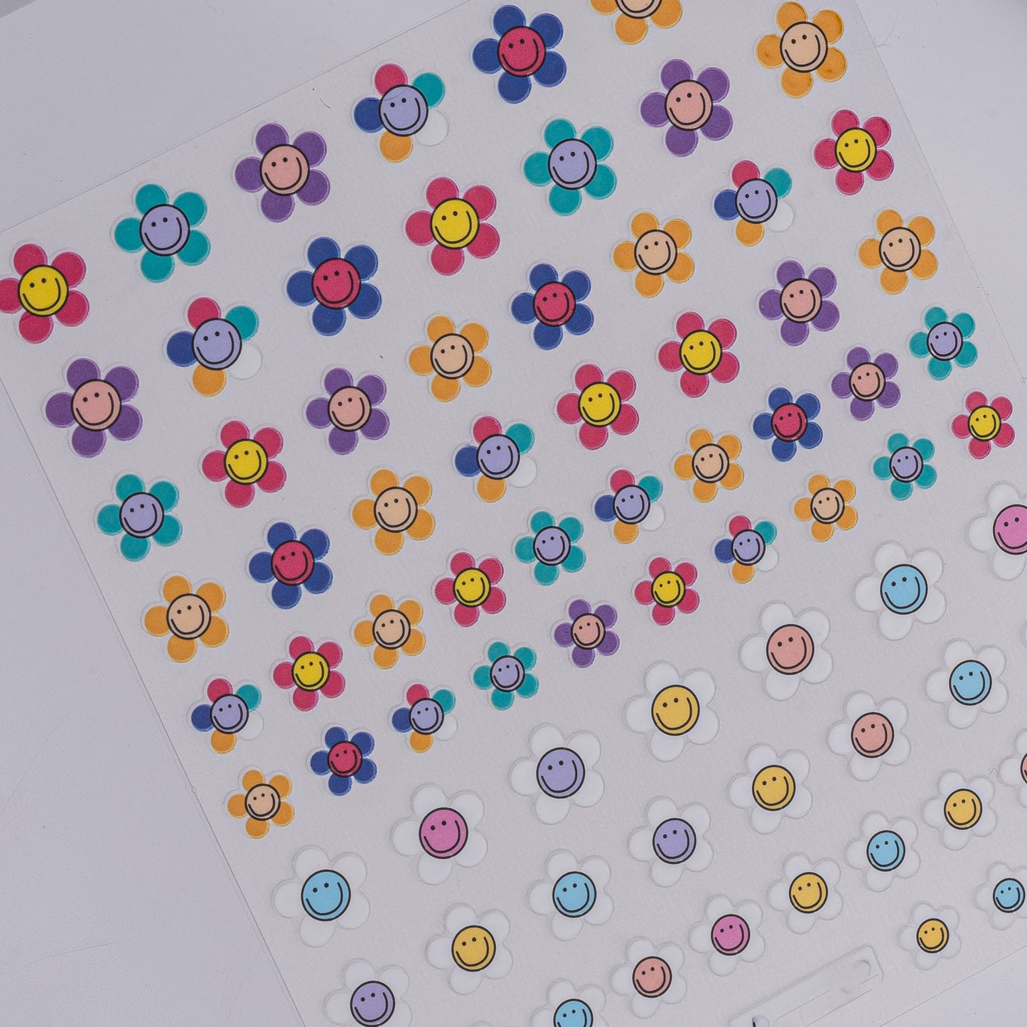 Sheet of colorful smiley face stickers on a white background