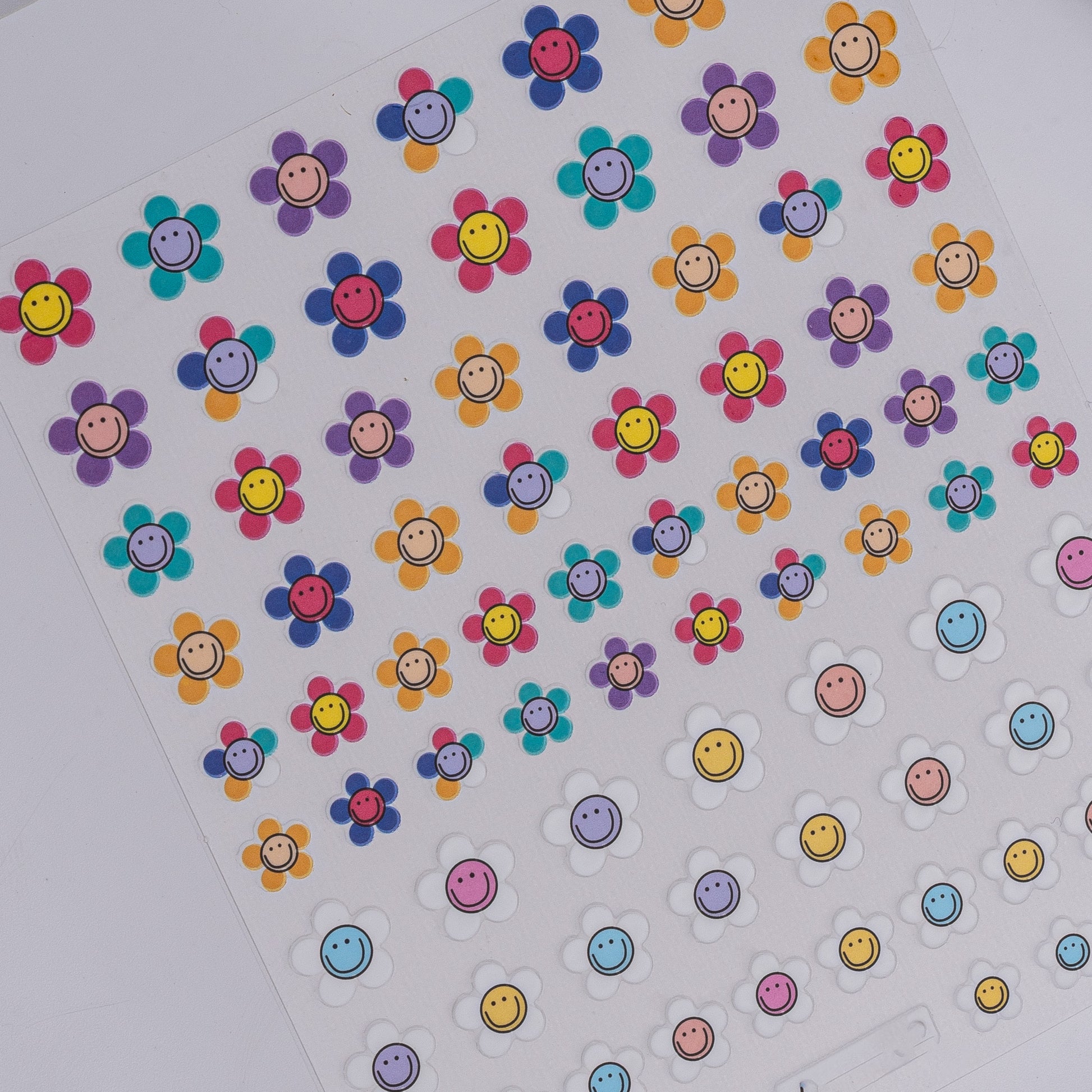 Sheet of colorful smiley face stickers on a white background