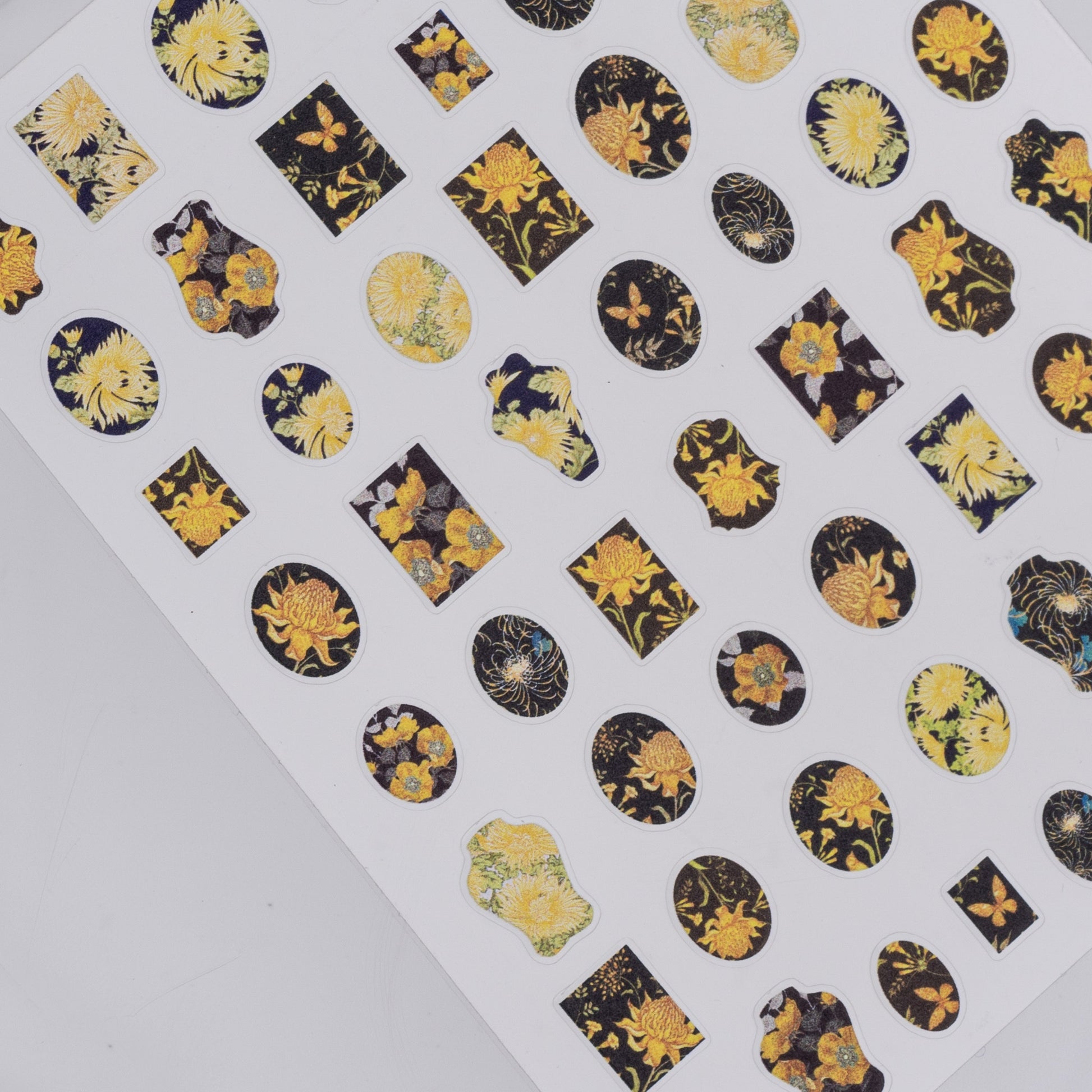 Sheet of decorative stickers with floral designs on a white background