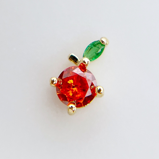 Rhinestone fruit charm on white background.