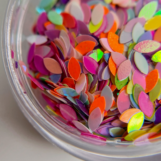 Multicolor glitter mix in clar jar on white background. 