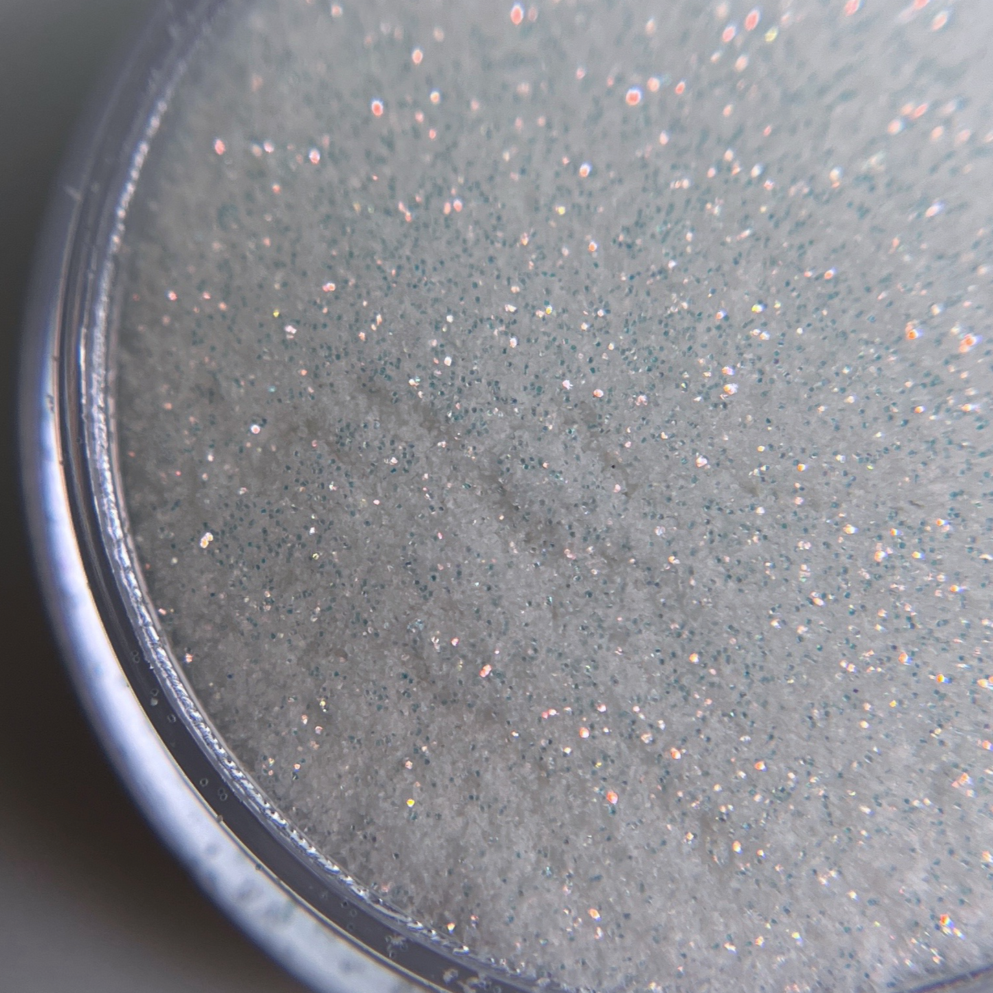 Close up of fine glitter in transparent jar