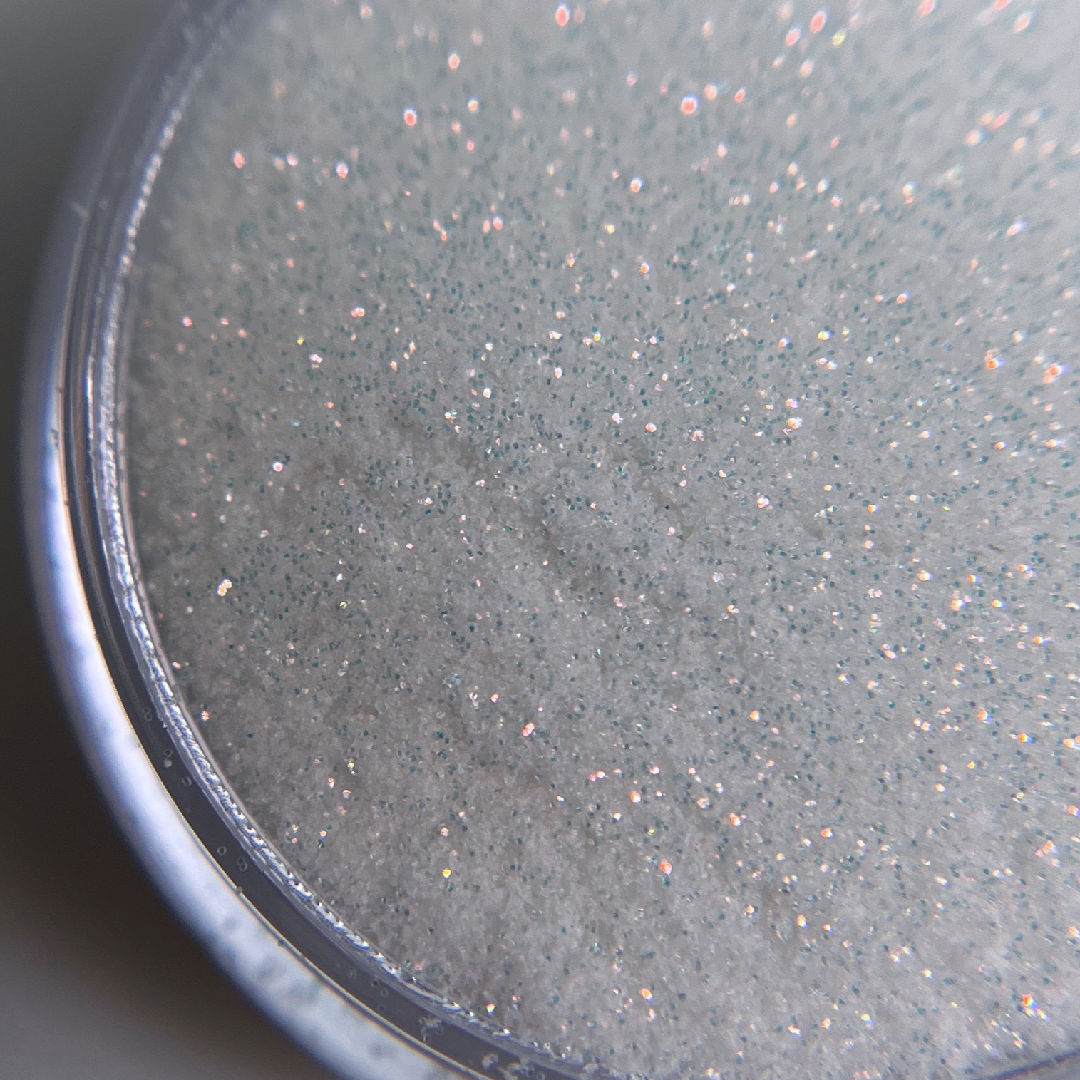 Close up of fine glitter in transparent jar