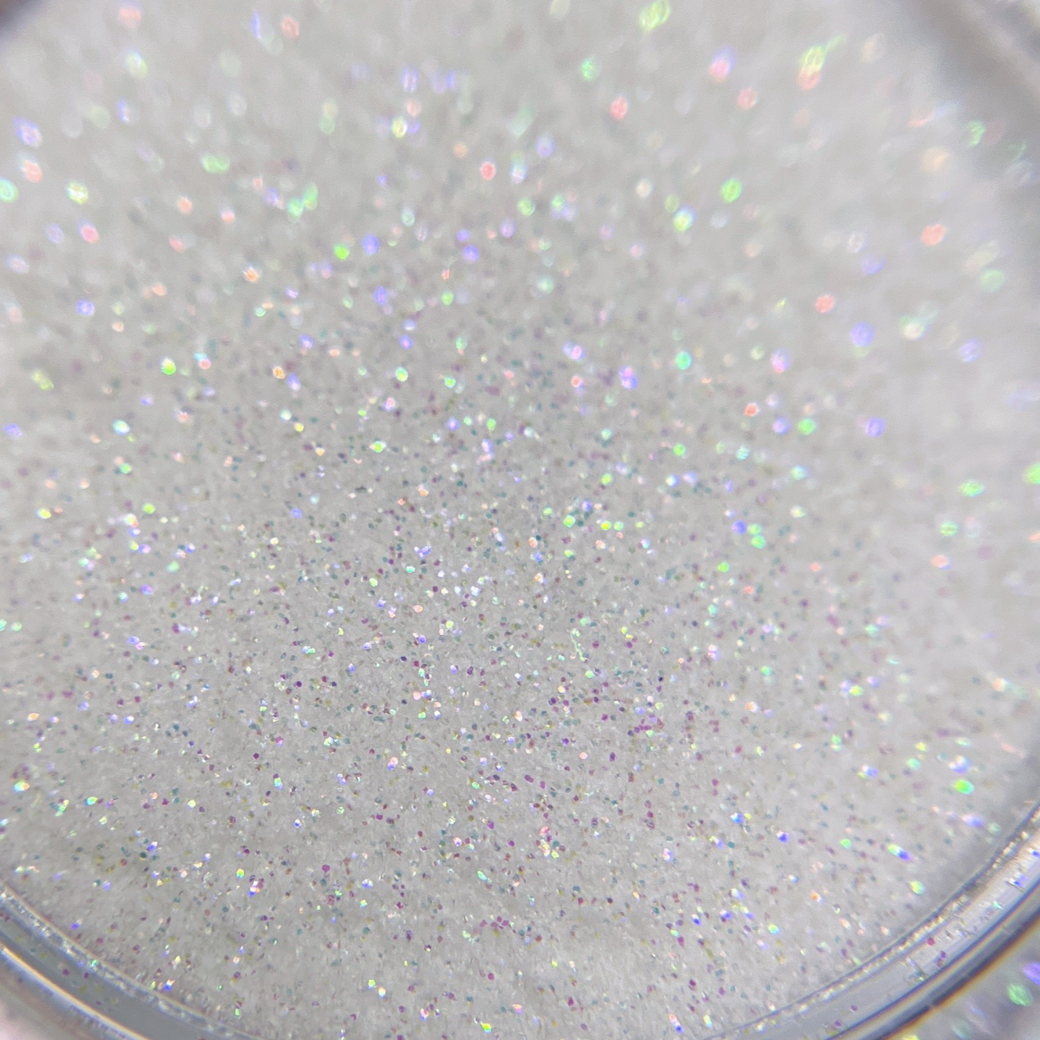 Close up of fine glitter particles in transparent jar