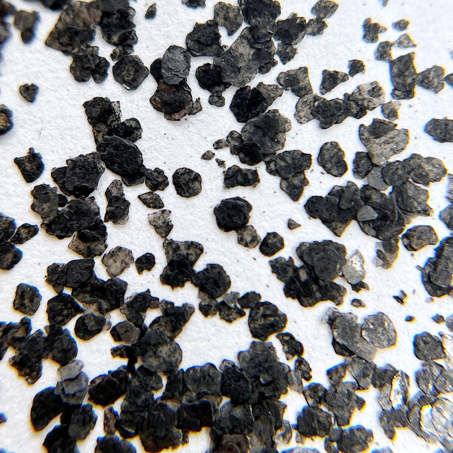 Speckle fragment glitter scattered on white background. 