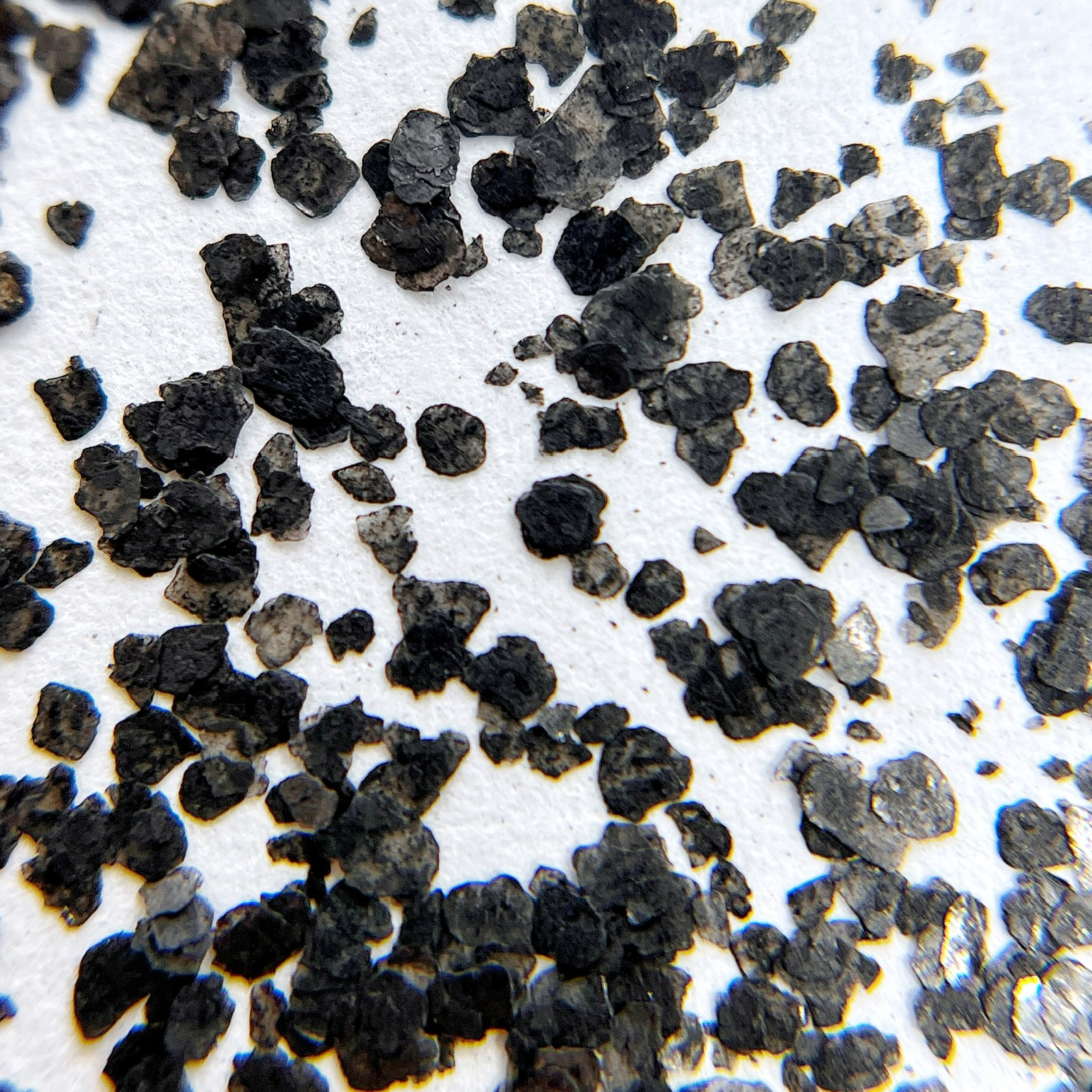 Speckle fragment glitter scattered on white background. 